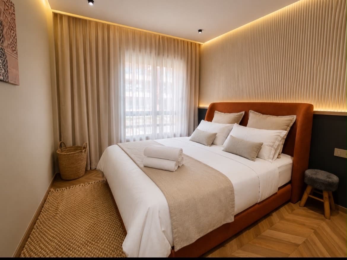 Bedroom prepared with hotel linen and towels before guests arrive